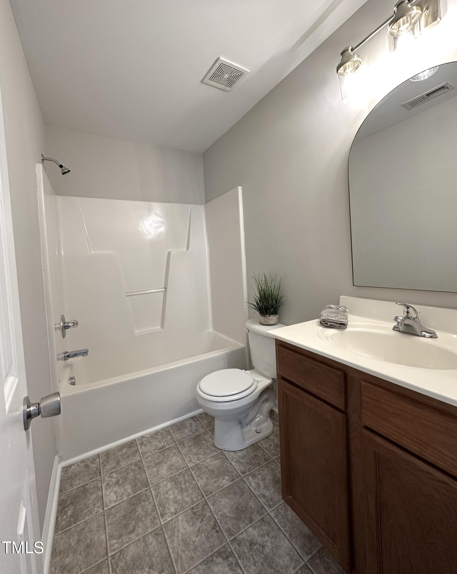 3847 Pin Oak Road Raleigh, NC 27604 - Photo 14 of 22 a bathroom with a sink a toilet and shower