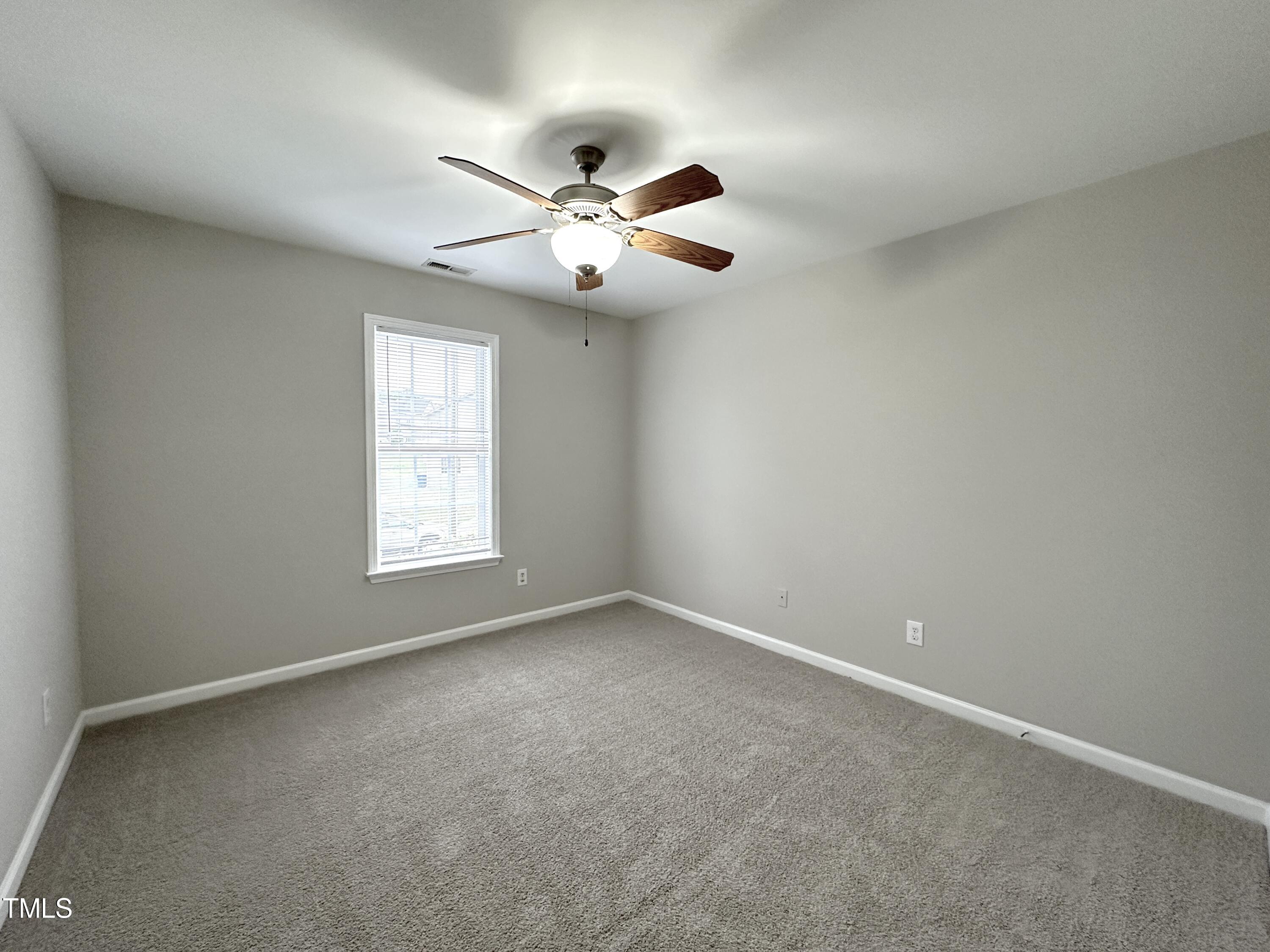 3847 Pin Oak Road Raleigh, NC 27604 - Photo 16 of 22 an empty room with windows and fan