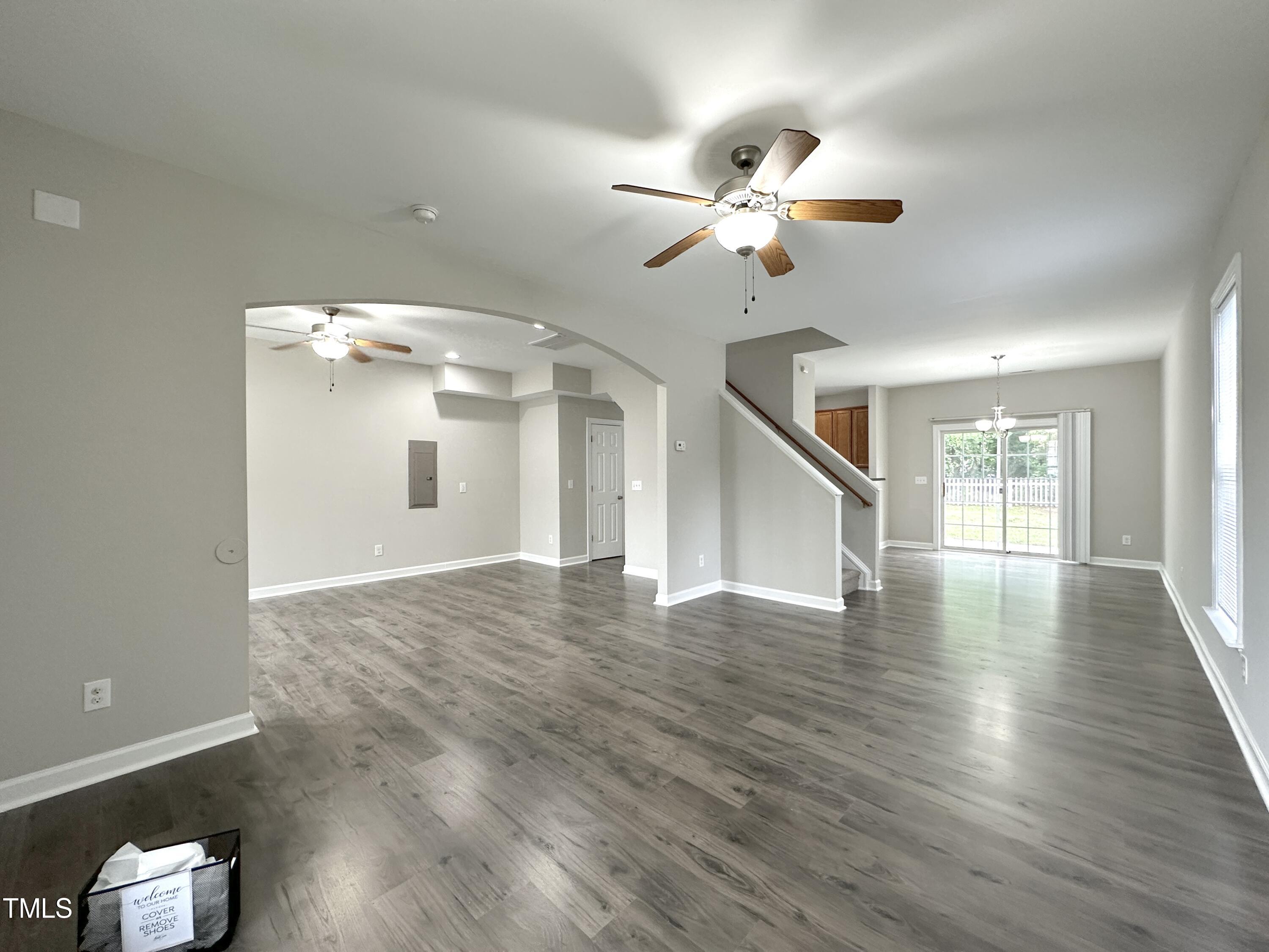 3847 Pin Oak Road Raleigh, NC 27604 - Photo 4 of 22 a view of an empty room with wooden floor and a ceiling fan