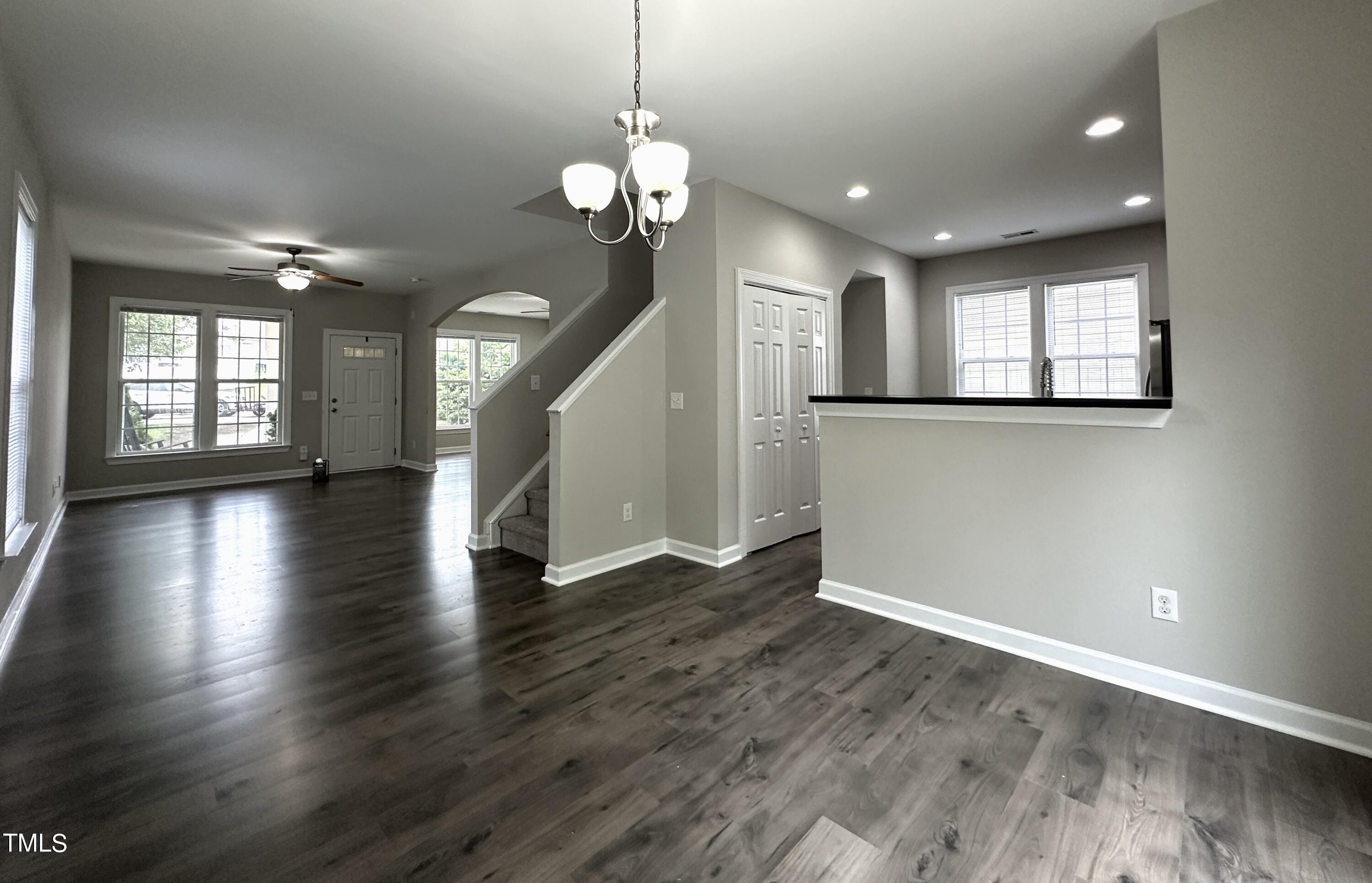 3847 Pin Oak Road Raleigh, NC 27604 - Photo 5 of 22 an empty room with wooden floor and windows