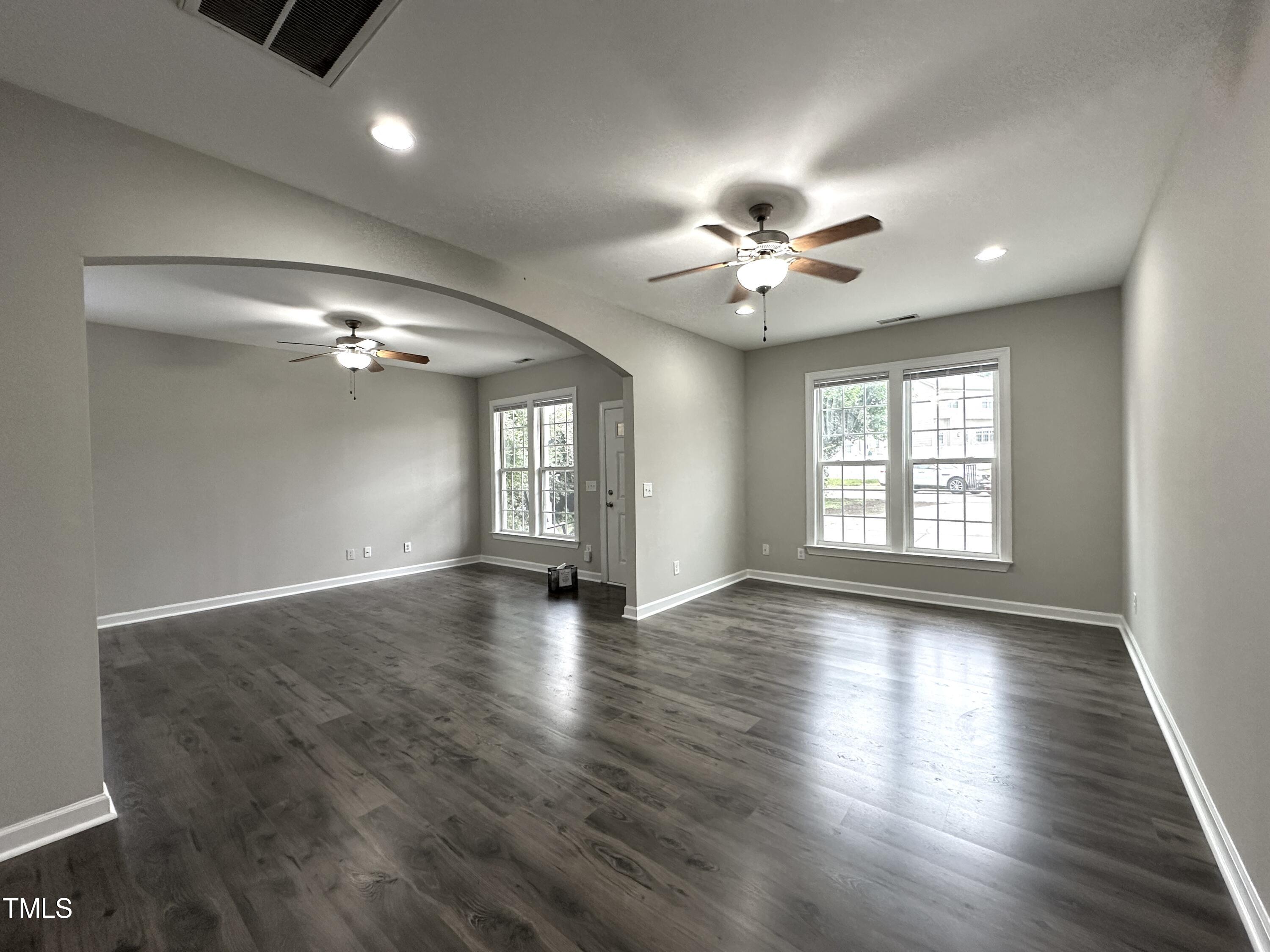 3847 Pin Oak Road Raleigh, NC 27604 - Photo 8 of 22 a view of an empty room with chandelier fan and wooden floor