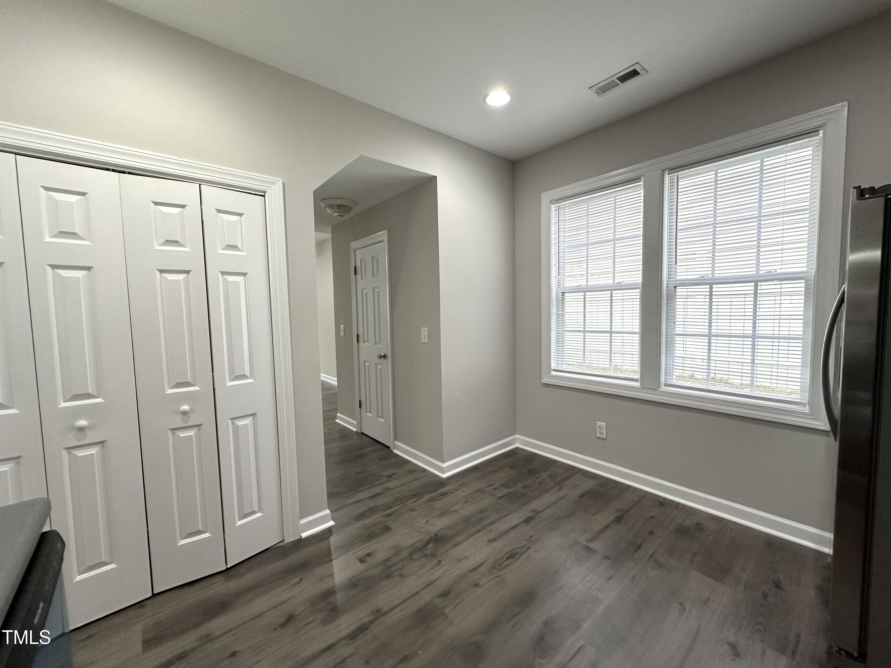 3847 Pin Oak Road Raleigh, NC 27604 - Photo 10 of 22 an empty room with wooden floor and windows