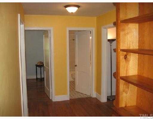 Like many homes built in the 1940's this classic brick ranch has a center hall way. This area is large and has solid wood built in cabinets and shelving and enough space to create a desk nook or small work space. Lots of storage and useful space!