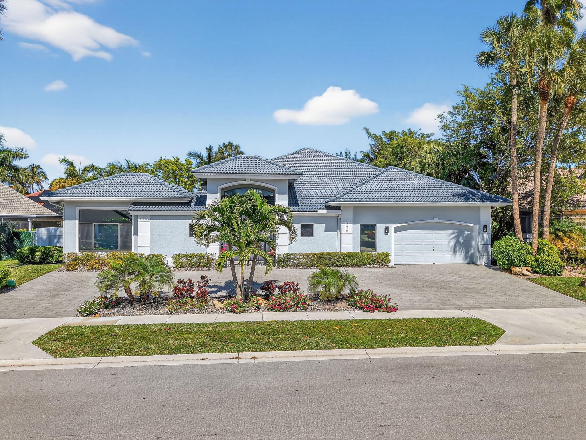 7075 Siena Court Boca Raton, FL 33433 - Photo 1 of 50 a front view of house with yard and outdoor seating