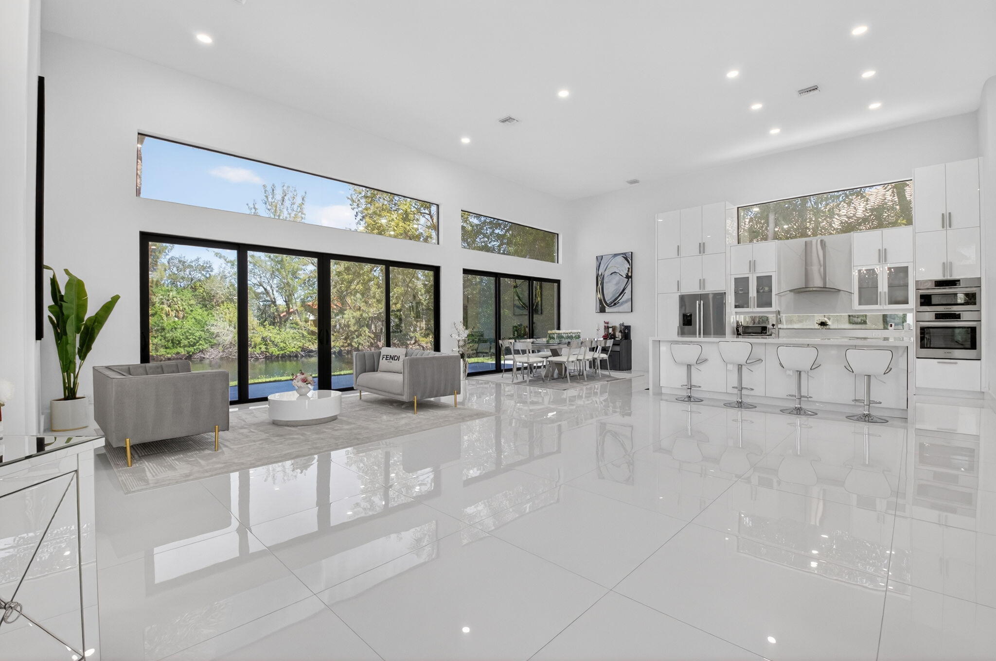 7075 Siena Court Boca Raton, FL 33433 - Photo 14 of 50 a living room with furniture large windows and a potted plant