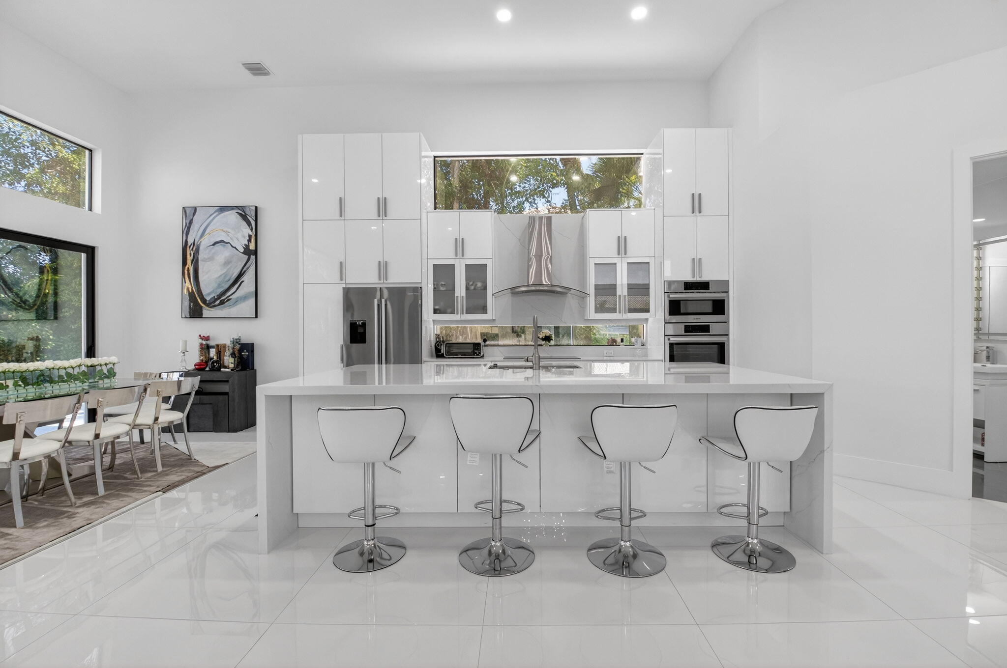 7075 Siena Court Boca Raton, FL 33433 - Photo 25 of 50 a kitchen with white cabinets and chairs