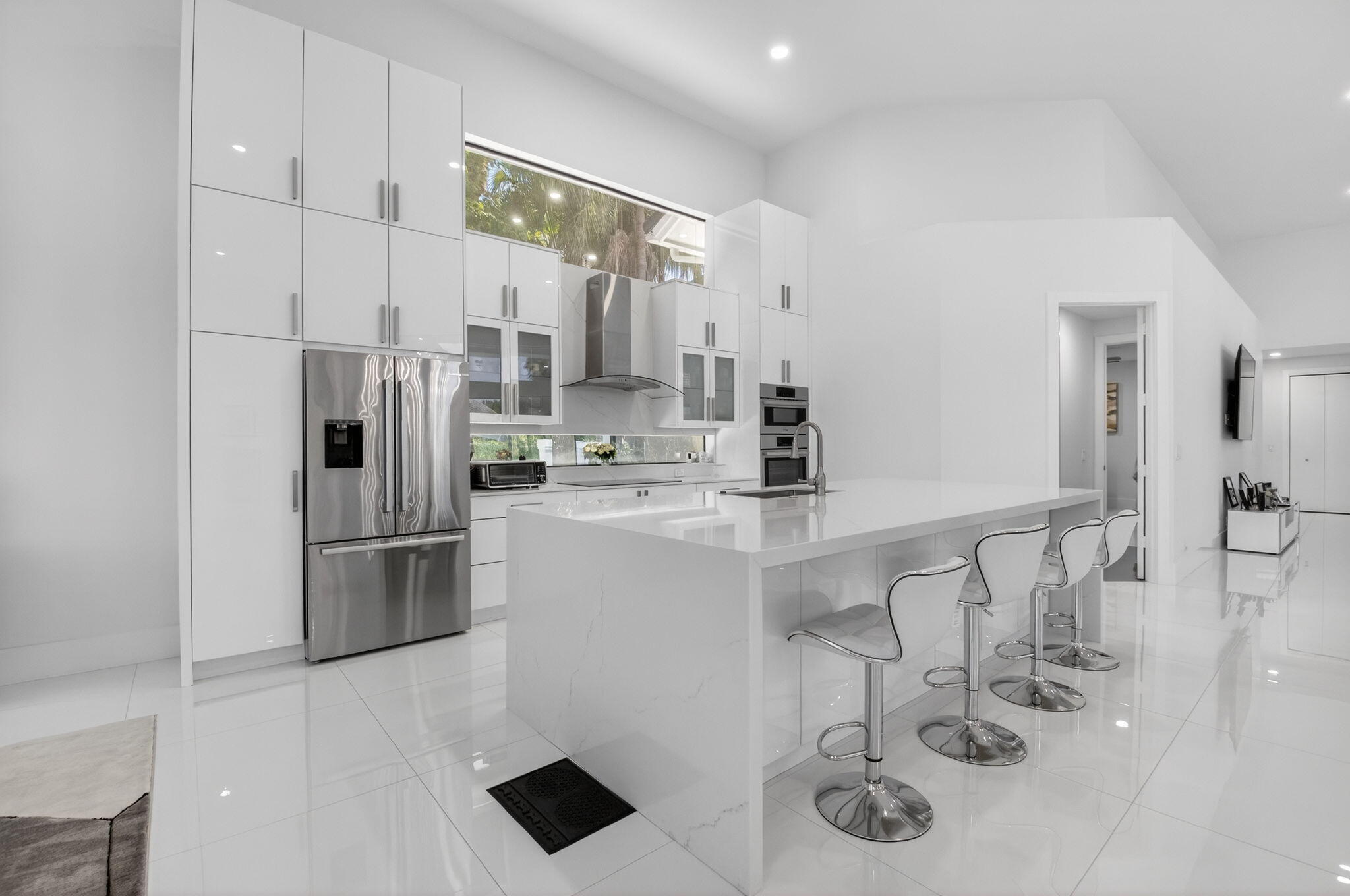 7075 Siena Court Boca Raton, FL 33433 - Photo 26 of 50 a kitchen with stainless steel appliances a refrigerator a sink a stove and white cabinets