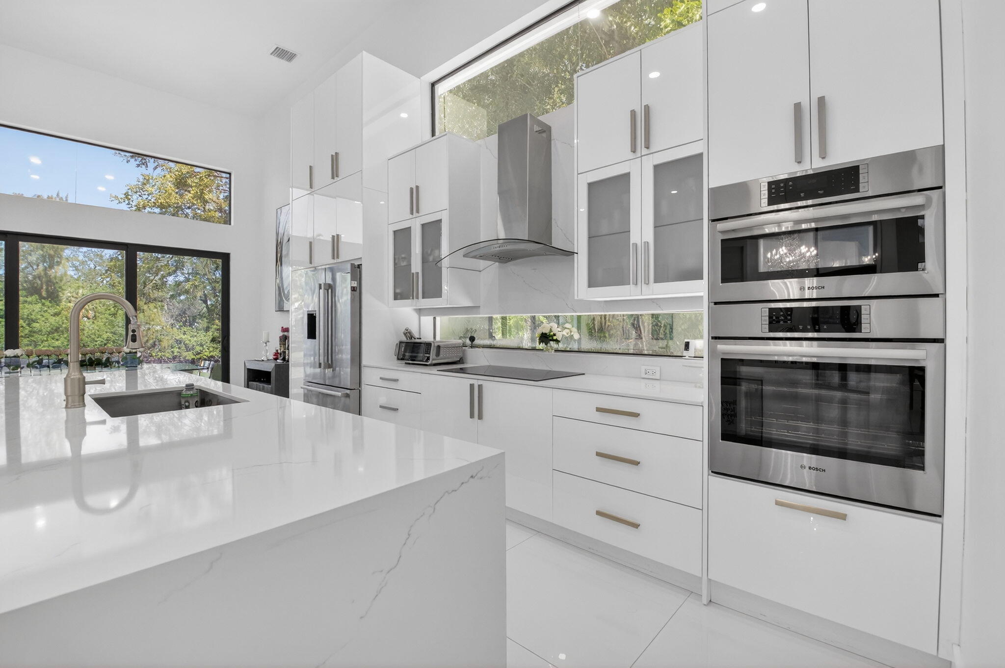 7075 Siena Court Boca Raton, FL 33433 - Photo 28 of 50 a kitchen with stainless steel appliances a stove a refrigerator and cabinets
