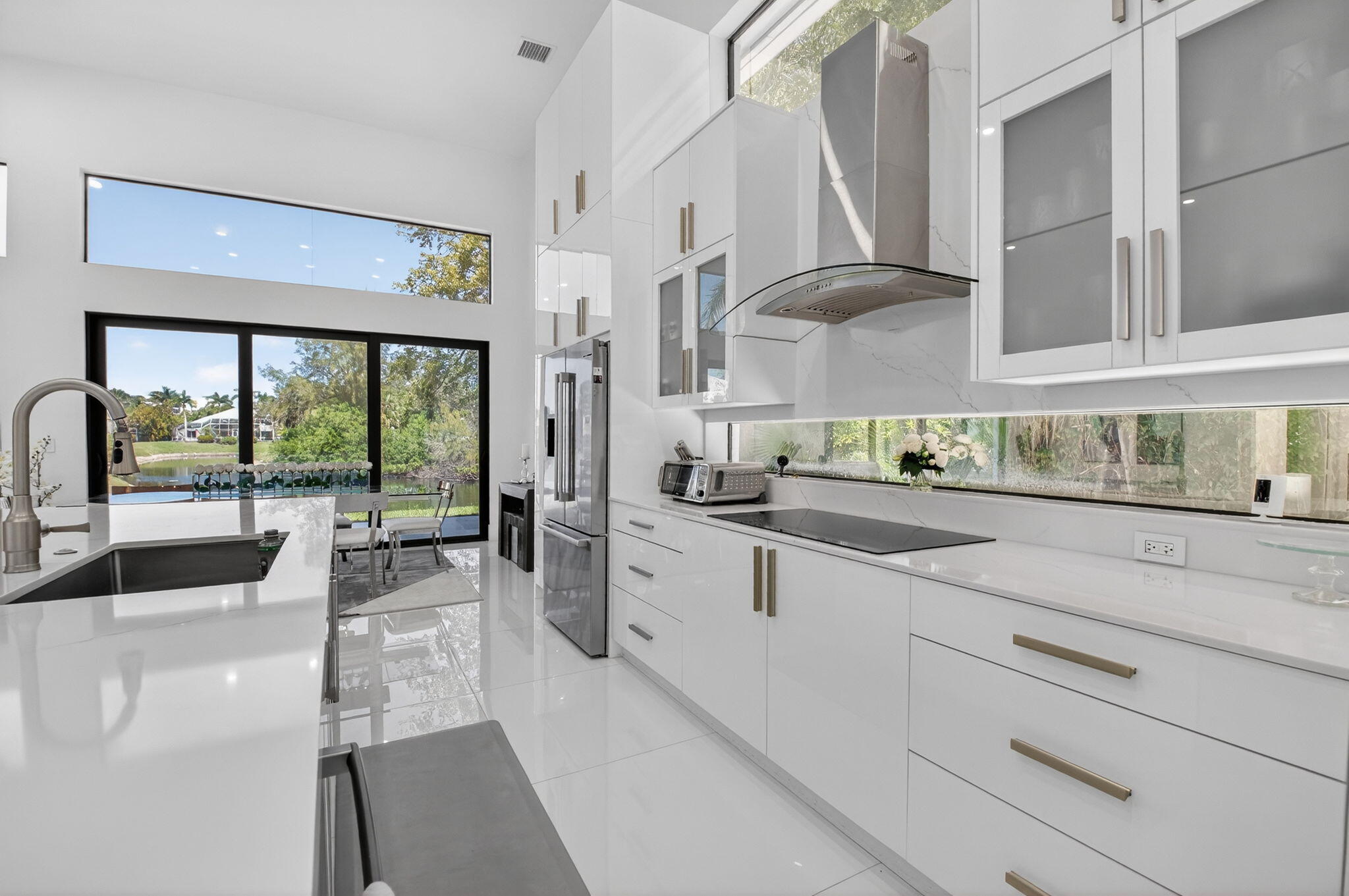 7075 Siena Court Boca Raton, FL 33433 - Photo 29 of 50 a large white kitchen with a large window