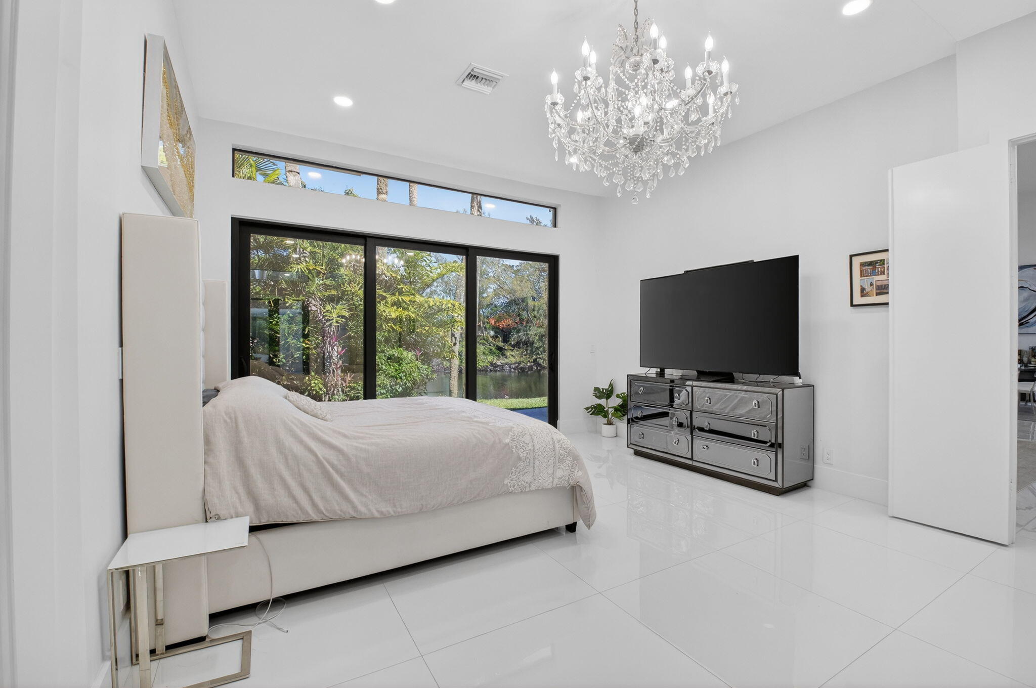 7075 Siena Court Boca Raton, FL 33433 - Photo 30 of 50 a bedroom with bed tv and window