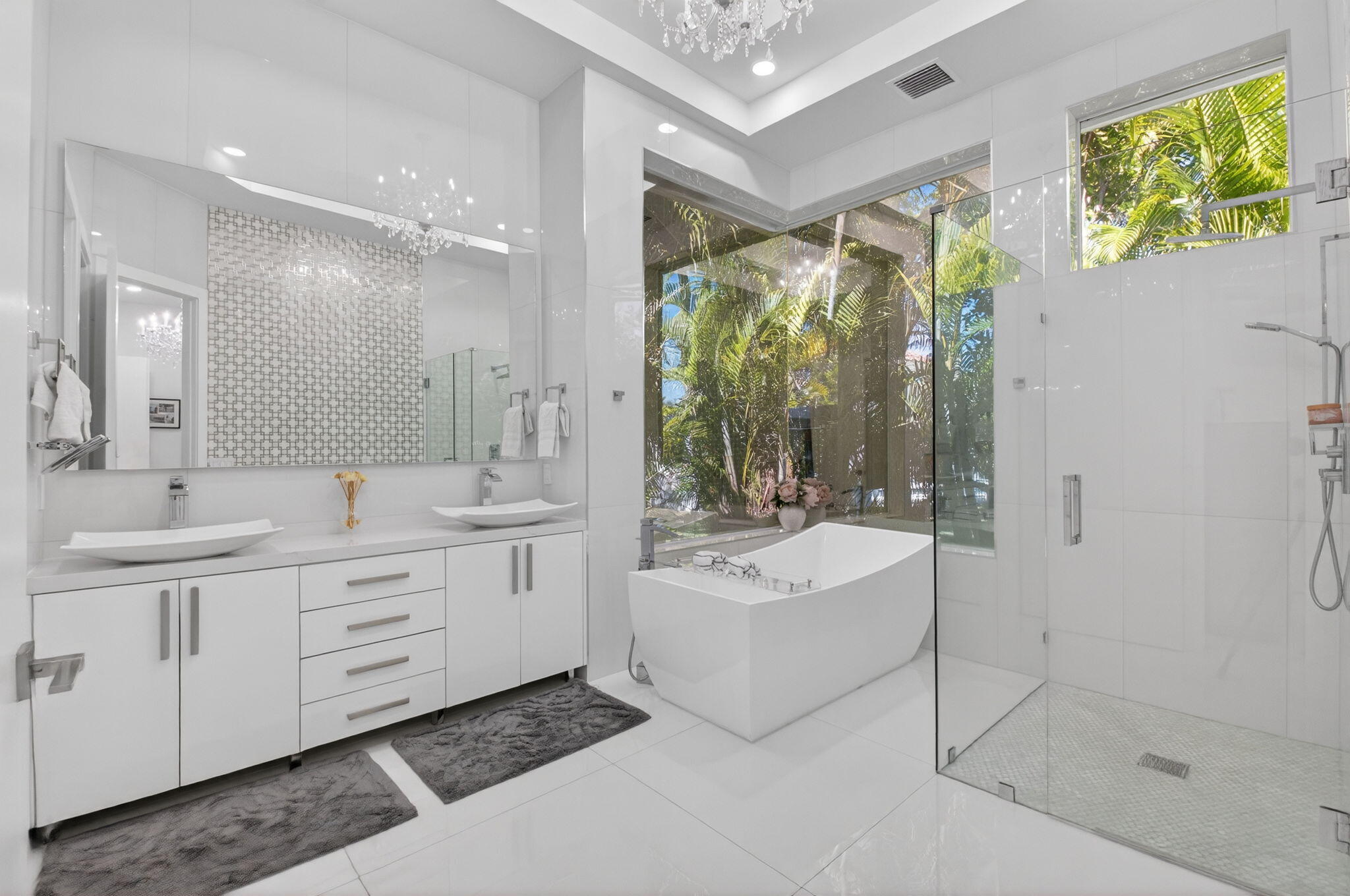 7075 Siena Court Boca Raton, FL 33433 - Photo 34 of 50 a bathroom with a double vanity sink mirror bathtub and shower