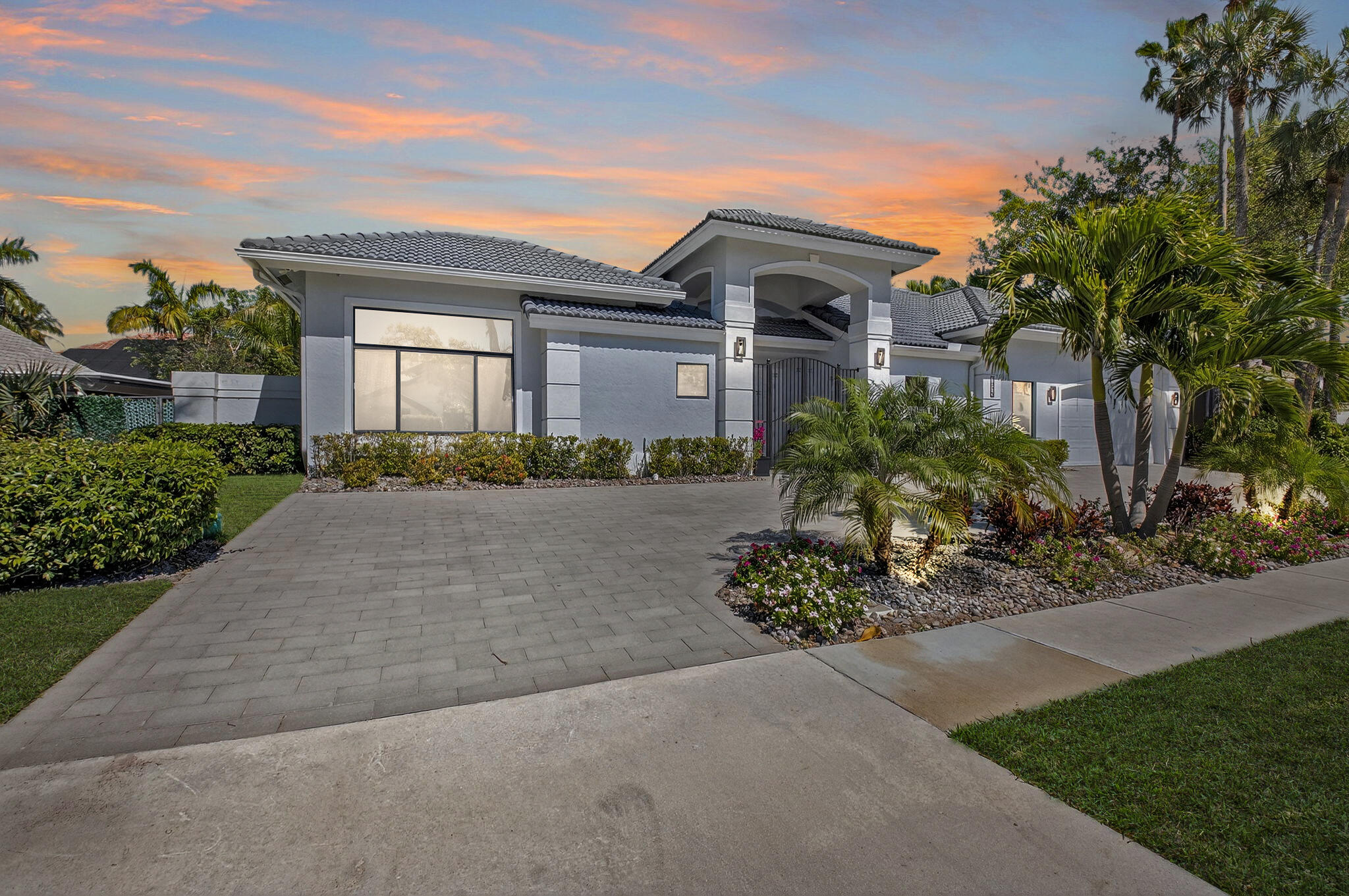7075 Siena Court Boca Raton, FL 33433 - Photo 4 of 50 a front view of a house with a garden