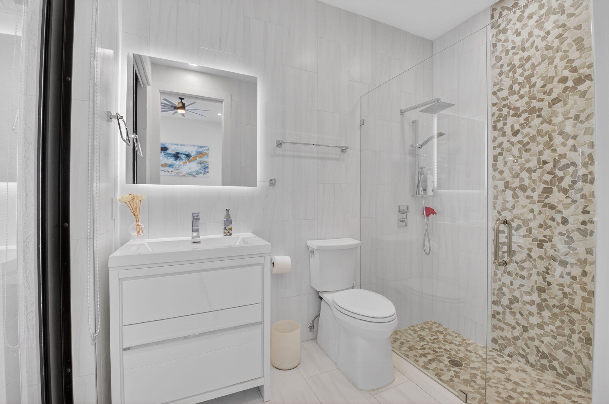 7075 Siena Court Boca Raton, FL 33433 - Photo 44 of 50 a bathroom with a toilet a sink and a mirror