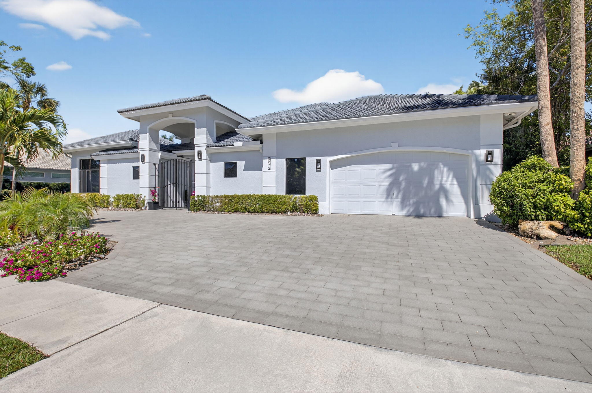 7075 Siena Court Boca Raton, FL 33433 - Photo 5 of 50 a front view of a house with a yard and garage