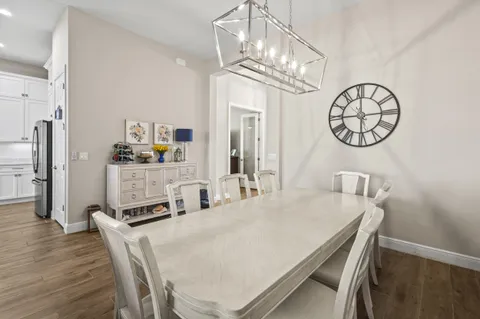 a kitchen with stainless steel appliances granite countertop a white cabinets and wooden floor