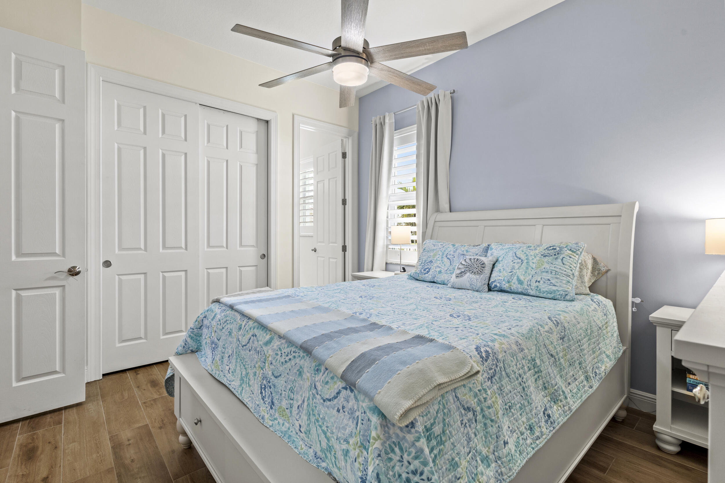 9242 Southwest Pepoli Way Port St. Lucie, FL 34987 - Photo 24 of 71 a bedroom with a large bed and wooden floor