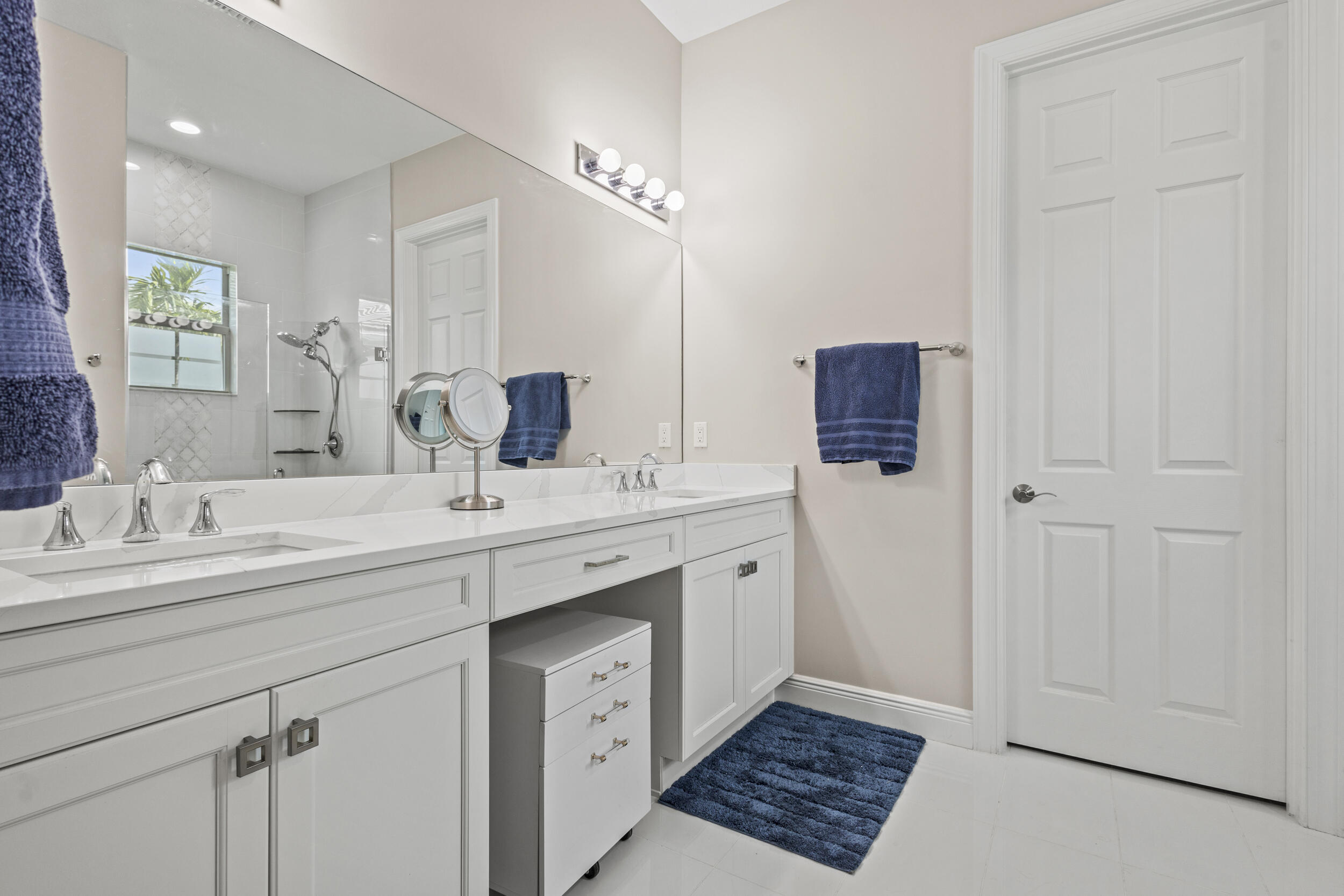 9242 Southwest Pepoli Way Port St. Lucie, FL 34987 - Photo 31 of 71 a spacious bathroom with a double vanity sink mirror and
