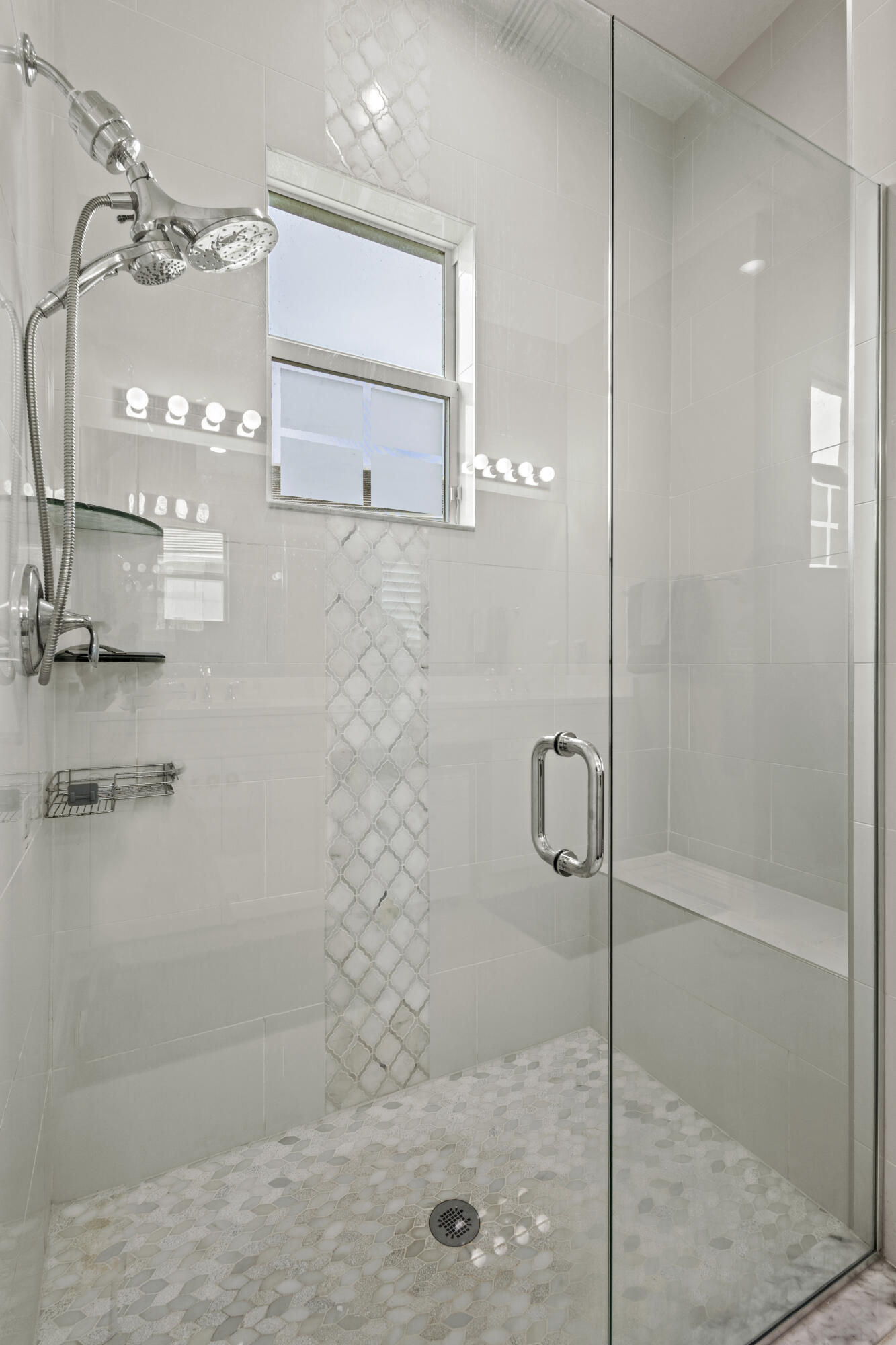 9242 Southwest Pepoli Way Port St. Lucie, FL 34987 - Photo 33 of 71 a bathroom with a glass shower door and a sink