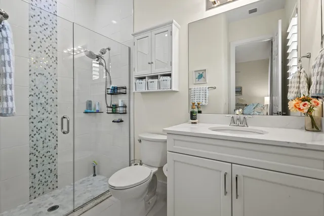 an aerial view of a house with a garden and lake view