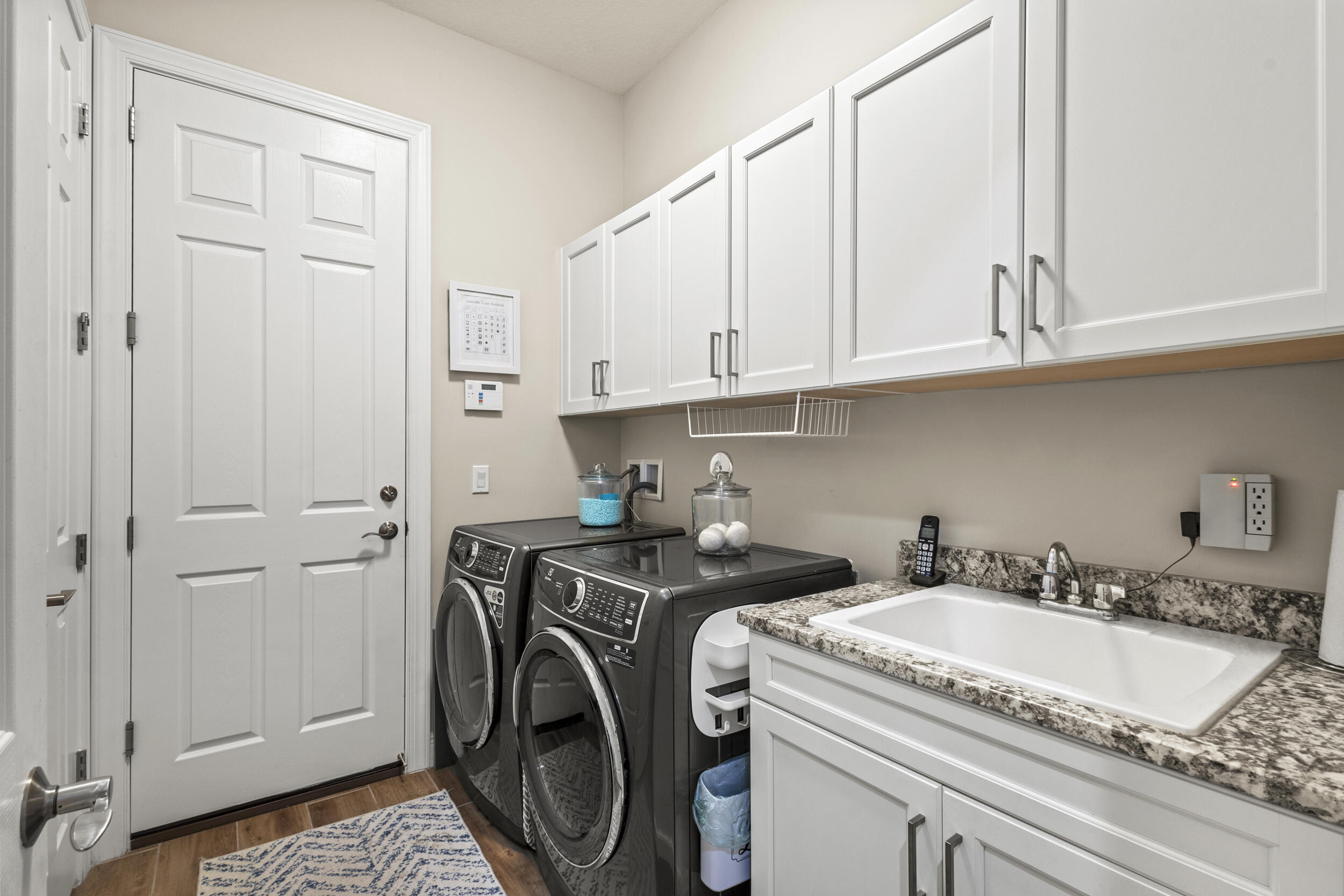 9242 Southwest Pepoli Way Port St. Lucie, FL 34987 - Photo 38 of 71 a view of a sink and washer dryer