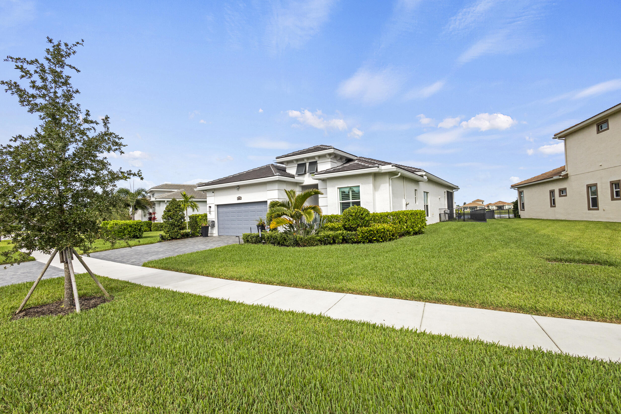 9242 Southwest Pepoli Way Port St. Lucie, FL 34987 - Photo 4 of 71 a front view of a house with a yard