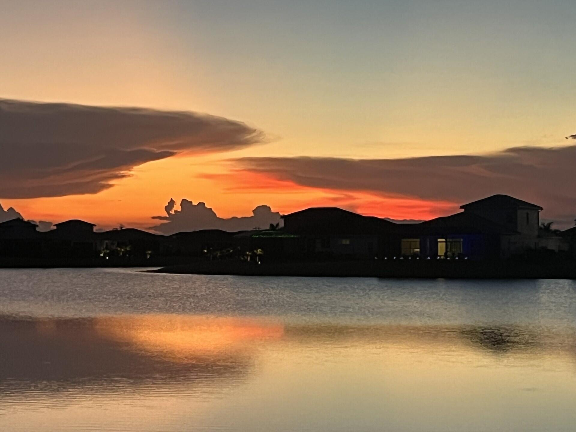9242 Southwest Pepoli Way Port St. Lucie, FL 34987 - Photo 49 of 71 a view of a lake with sunset