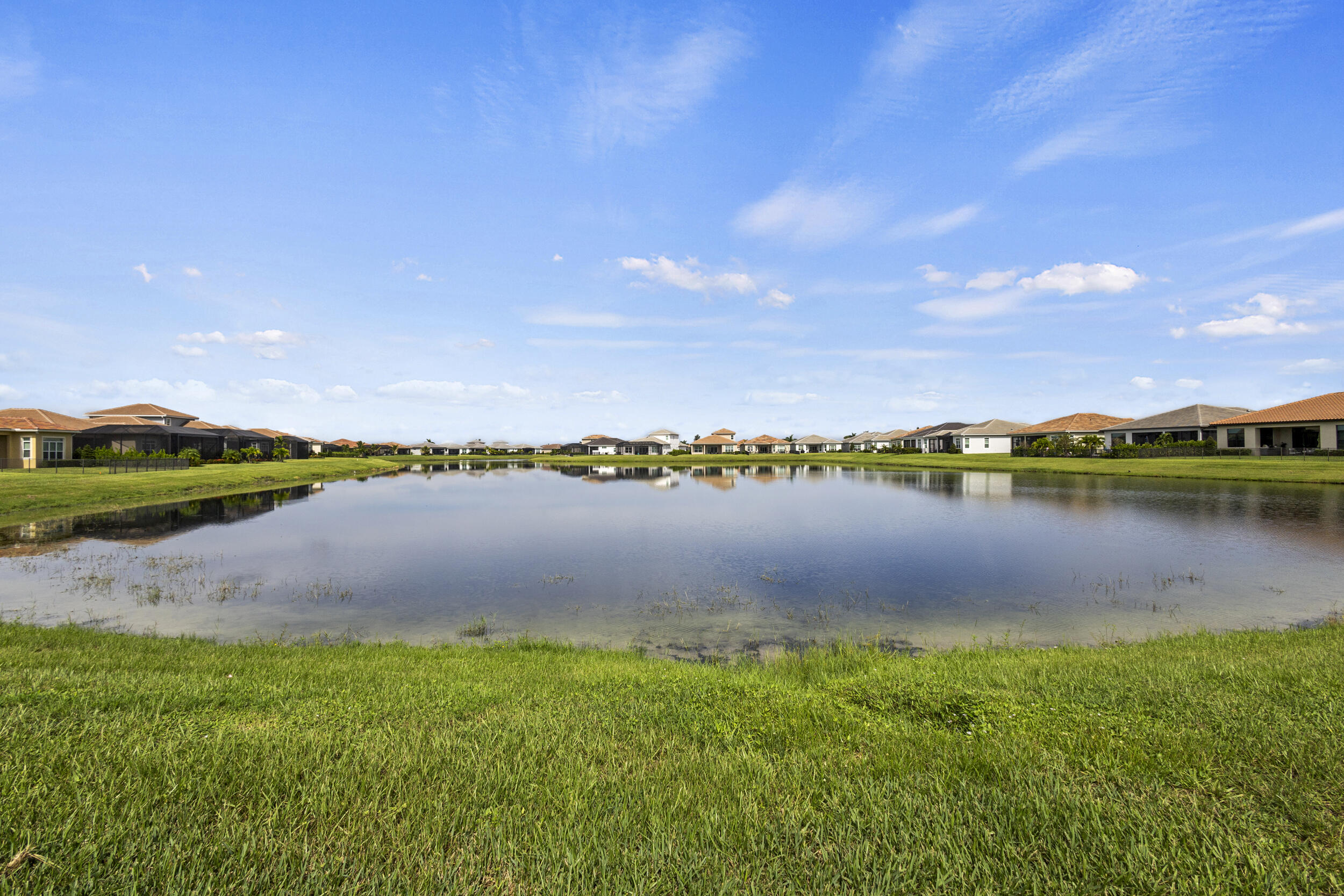 9242 Southwest Pepoli Way Port St. Lucie, FL 34987 - Photo 52 of 71 a view of a lake with houses in the back