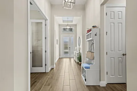 a living room with furniture a flat screen tv and a window