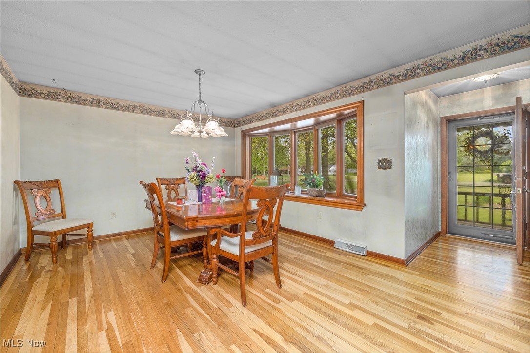 11811 Robson Road Grafton, OH 44044 - Photo 7 of 50 Dining room with light wood-type flooring, baseboards, and plenty of natural light