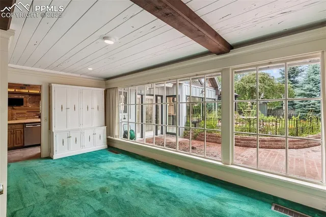 wooden floor fireplace and windows in an empty room