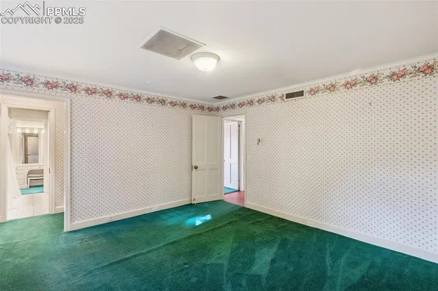 a view of an empty room with a fireplace and a window