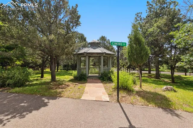 a view of an house with swimming pool garden and patio