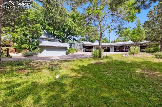 a view of a house with swimming pool and sitting area