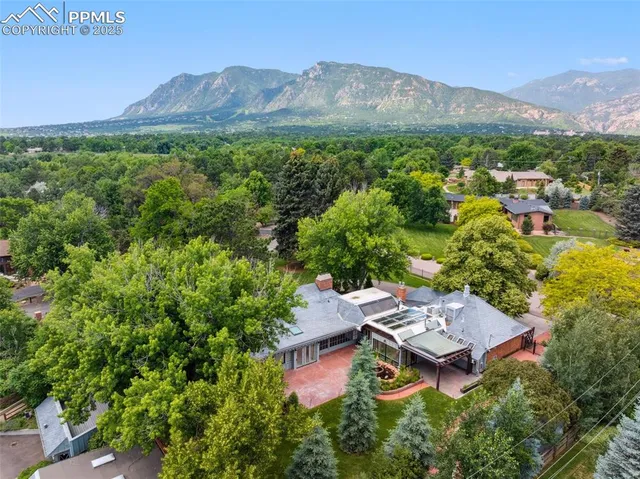 an aerial view of a house with a yard