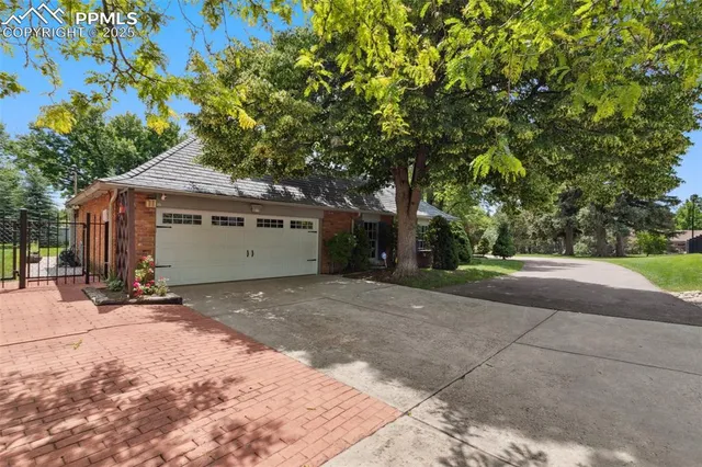 a view of a house with a tree and yard