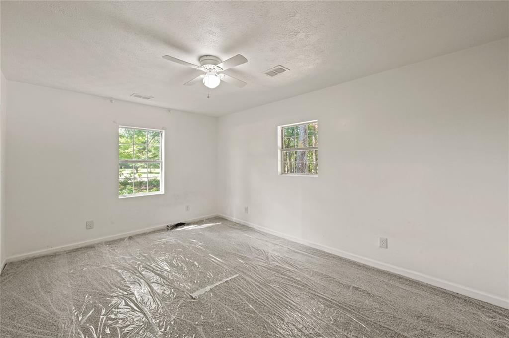 759 Smyrna Road Southwest Conyers, GA 30094 - Photo 17 of 25 a view of an empty room with a window