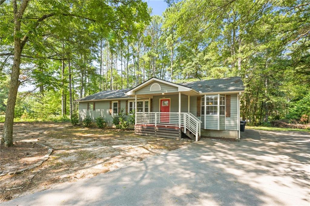 759 Smyrna Road Southwest Conyers, GA 30094 - Photo 2 of 25 a front view of a house with a yard
