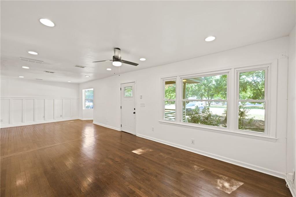 759 Smyrna Road Southwest Conyers, GA 30094 - Photo 5 of 25 an empty room with wooden floor and windows