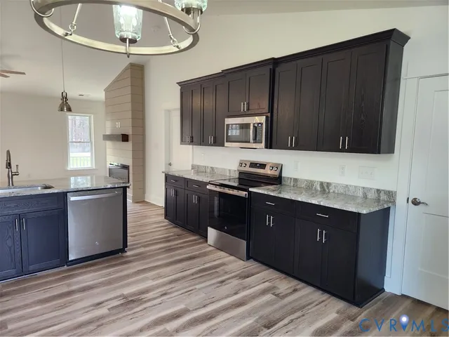 a kitchen with a sink stove and refrigerator