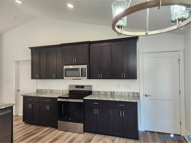 a kitchen with stainless steel appliances granite countertop a stove a sink dishwasher and a microwave oven