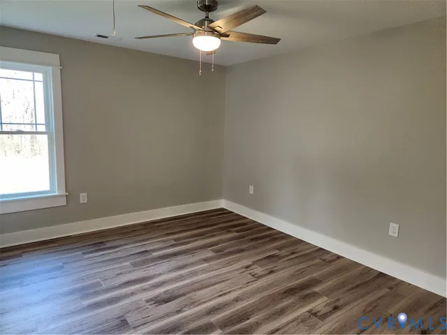 a bathroom with a granite countertop sink a toilet and a mirror