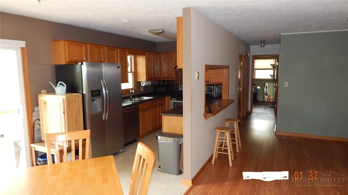 190 Kings Road Boone, NC 28607 - Photo 5 of 15 a kitchen with stainless steel appliances refrigerator and wooden floor
