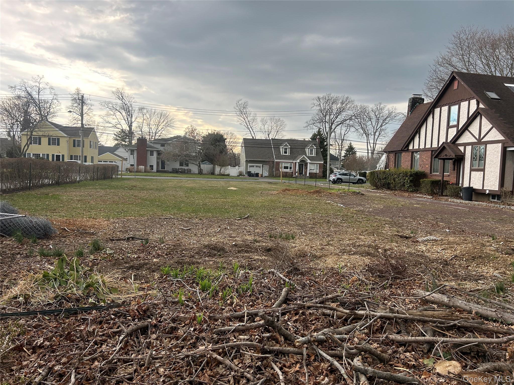 Sunset Road Bay Shore, NY 11706 - Photo 4 of 6 a view of a big house in a big yard with large trees