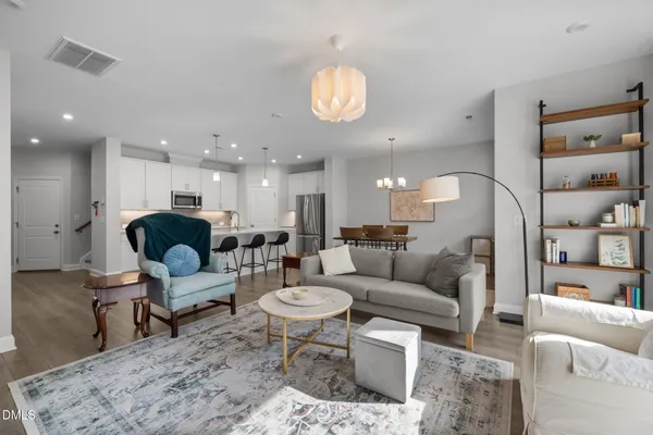 a living room with furniture a mirror and a table