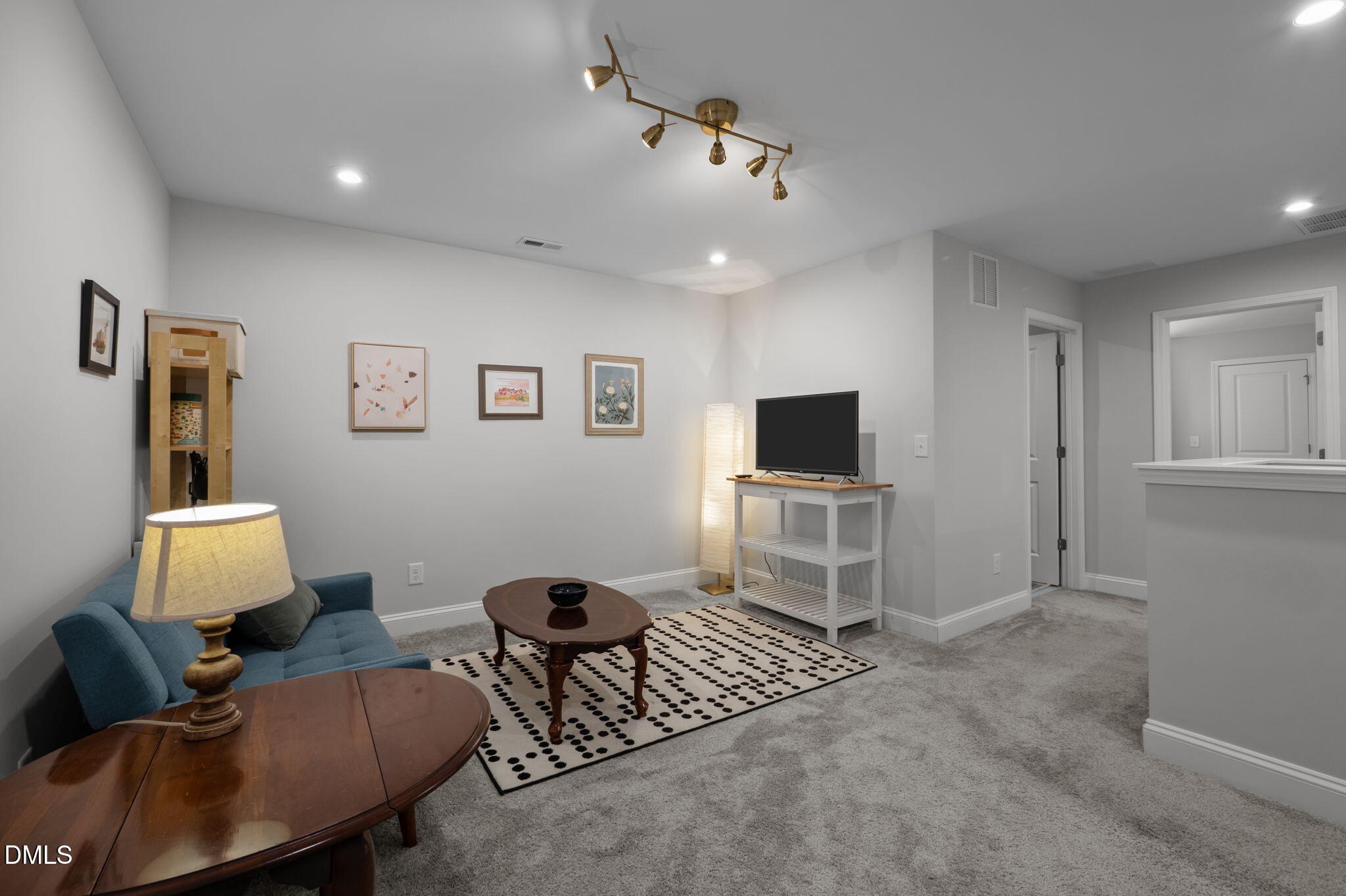 6523 Amber Springs Drive Durham, NC 27713 - Photo 15 of 32 a living room with furniture and a flat screen tv