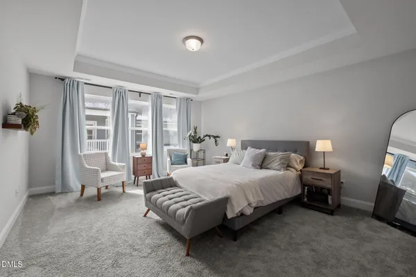 a spacious bedroom with a bed and large windows