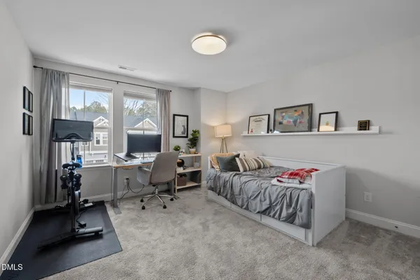a bedroom with a bed and a book shelf