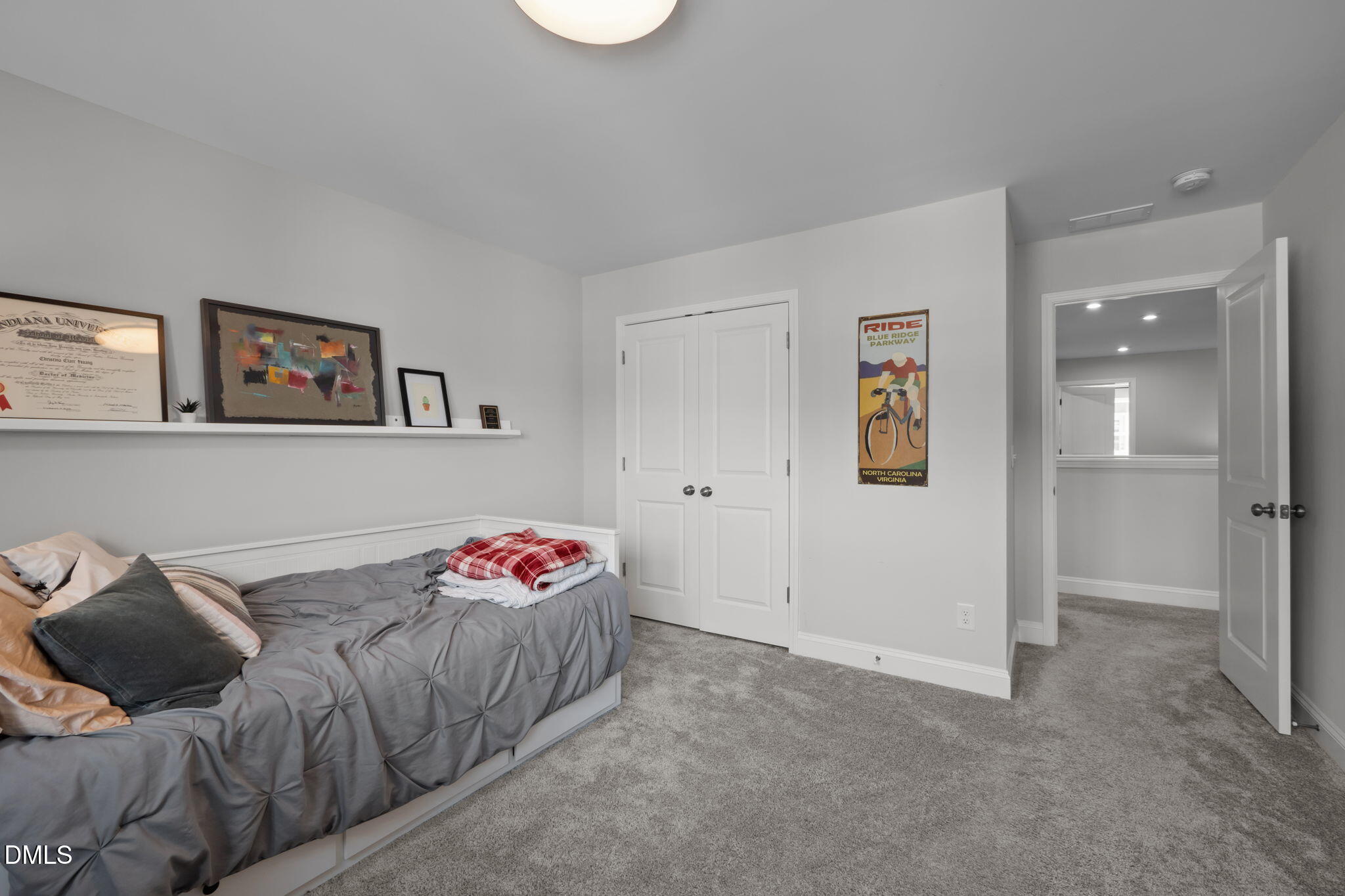 6523 Amber Springs Drive Durham, NC 27713 - Photo 20 of 32 a bedroom with a bed and a couch