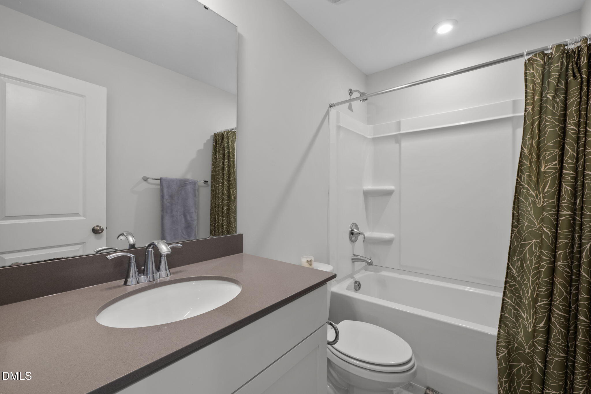 6523 Amber Springs Drive Durham, NC 27713 - Photo 22 of 32 a bathroom with a granite countertop sink toilet a mirror and shower