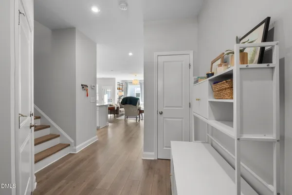 a view of hallway with wooden floor and staircase